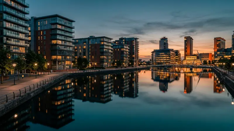 Victorian red brick warehouse in Manchester being converted into modern apartments with scaffolding and construction activity